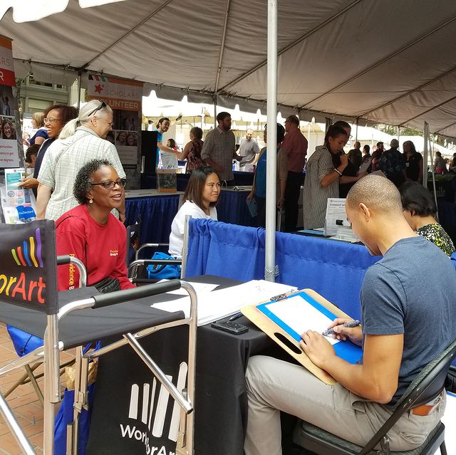 Uri Frazier, drawing caricatures at an outdoor event for Work For Art in Portland, OR.